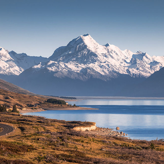 Photograph of a snow-capped mountain range and lake